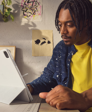 A person uses their iPad Air in a Smart Folio at a safe viewing distance